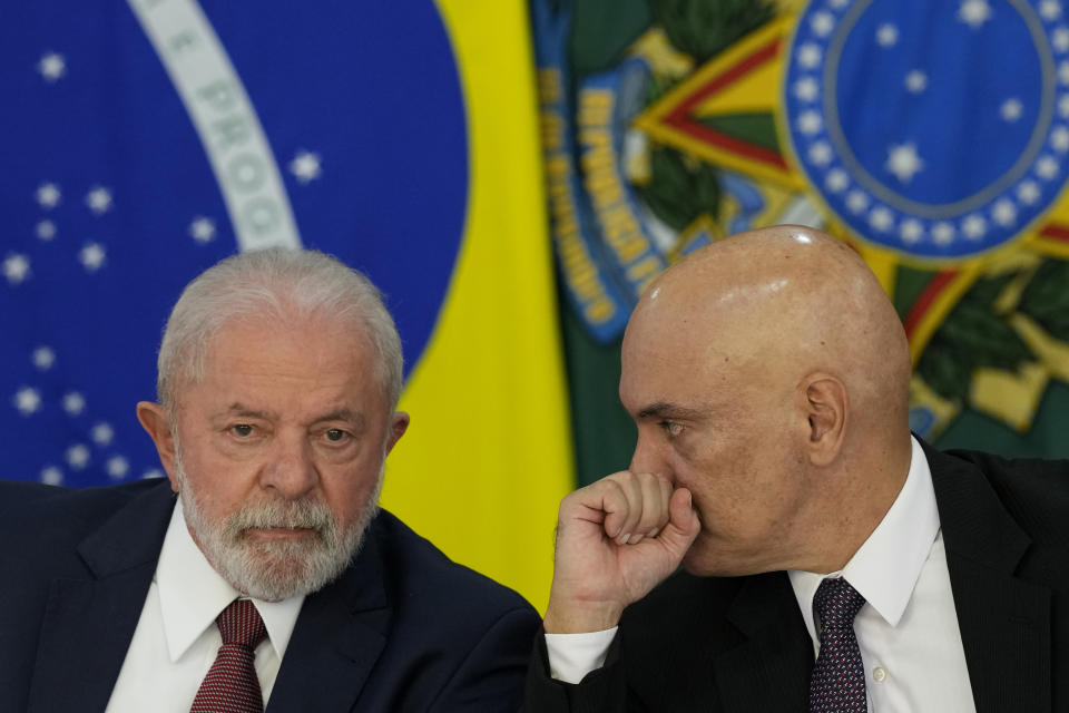 Brazil's President Luiz Inacio Lula da Silva, left, and Supreme Court Justice Alexandre de Moraes, attend a meeting regarding school security, at the Planalto Palace in Brasilia, Brazil, Tuesday, April 18, 2023. Educators, government security officials and school administrators have gathered to devise plans to deal with a wave of school violence that has left at least 4 children and one teacher dead. (AP Photo/Eraldo Peres)