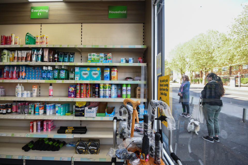 Customers queue outside Copes Pharmacy in Streatham, as the UK continues in lockdown to help curb the spread of the coronavirus.