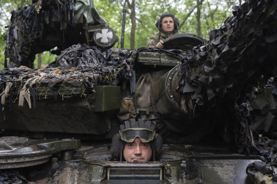 Ukrainian soldiers on a tank look on as they ride along the road towards their positions near Bakhmut, Donetsk region, Ukraine, Tuesday, May 23, 2023.(AP Photo/Efrem Lukatsky)