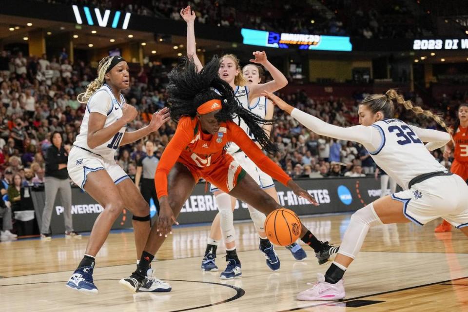 Mar 24, 2023; Greenville, SC, USA; Miami Hurricanes forward Lola Pendande (21) loses the ball chased by Villanova Wildcats guard Bella Runyan (32) during the second half of the NCAA Women’s Tournament at Bon Secours Wellness Arena. Mandatory Credit: Jim Dedmon-USA TODAY Sports