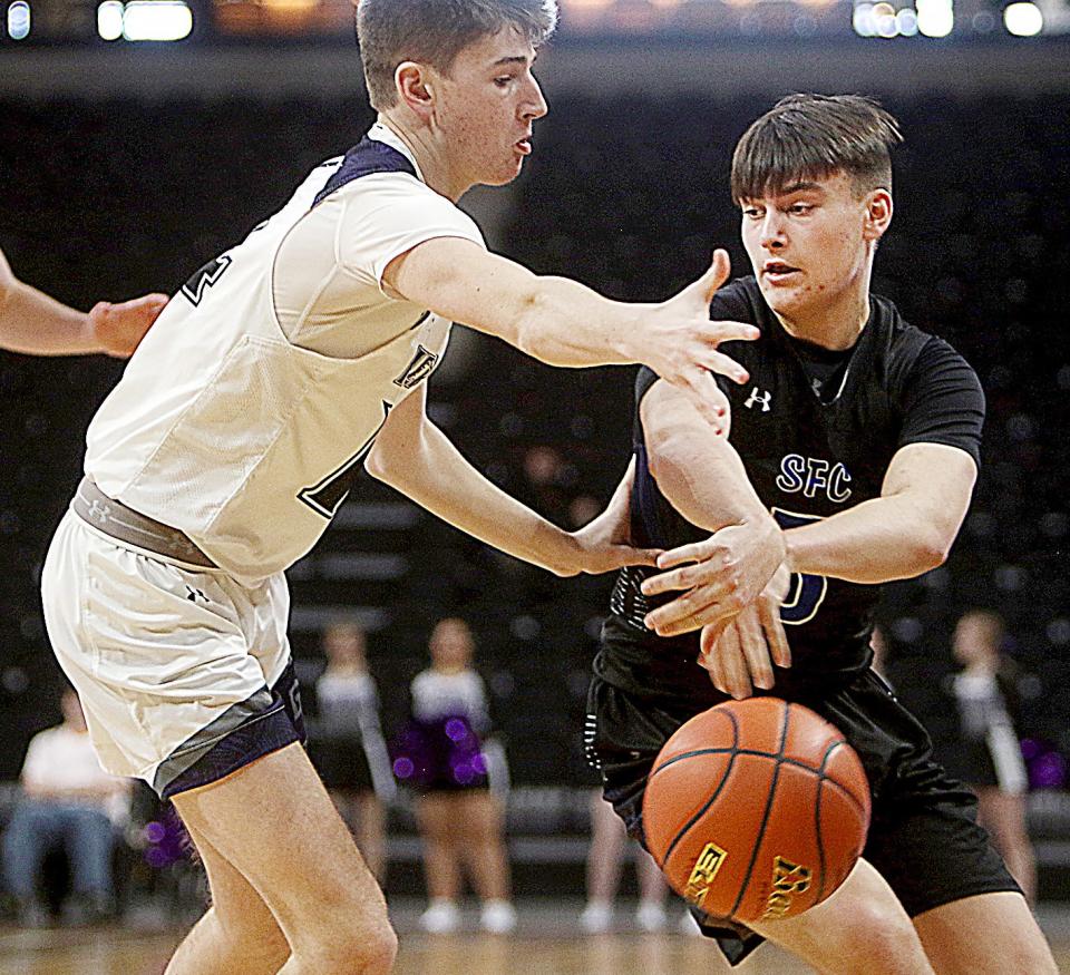 Sioux Falls Christian's Ethan Bruns passes around Dakota Valley's Sam Faldmo during their first-round game in the 2022 state Class A boys basketball tournament at Rapid City.