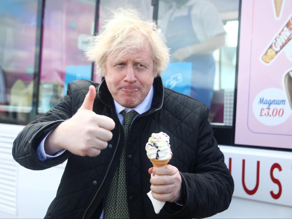 Mr Johnson tucking into an ice cream during a visit to Haven Perran Sands Holiday Park in Perranporth, Cornwall, in April 2021 (PA)