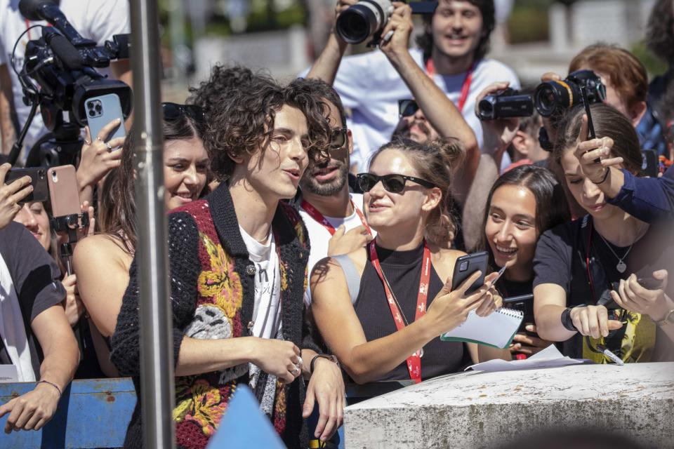 Timothee Chalamet speaks with fans upon arrival for the photo call of the film 'Bones and All' during the 79th edition of the Venice Film Festival in Venice, Italy, Friday, Sept. 2, 2022. (Photo by Vianney Le Caer/Invision/AP)