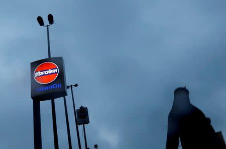 A woman walks past a logo of Indian Oil outside a fuel station in New Delhi, August 29, 2016. REUTERS/Adnan Abidi/Files