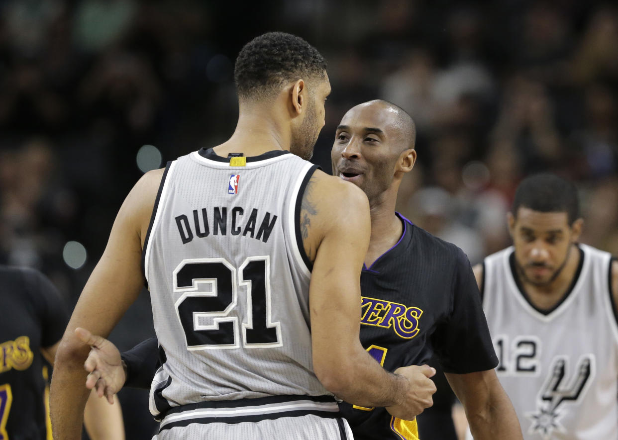San Antonio Spurs center Tim Duncan (21) hugs Los Angeles Lakers forward Kobe Bryant (24) prior to an NBA basketball game, Friday, Dec. 11, 2015, in San Antonio. (AP Photo/Eric Gay)