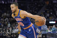 Golden State Warriors guard Stephen Curry drives to the basket against the San Antonio Spurs during the second half of an NBA basketball game in San Francisco, Saturday, Dec. 4, 2021. (AP Photo/Jeff Chiu)