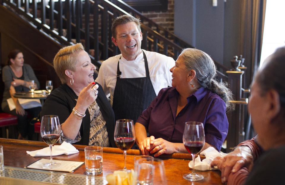 In this photo taken Monday, Oct. 29, 2012, chef Tyler Florence visits with customers at his Wayfare Tavern in San Francisco. (AP Photo/Eric Risberg)