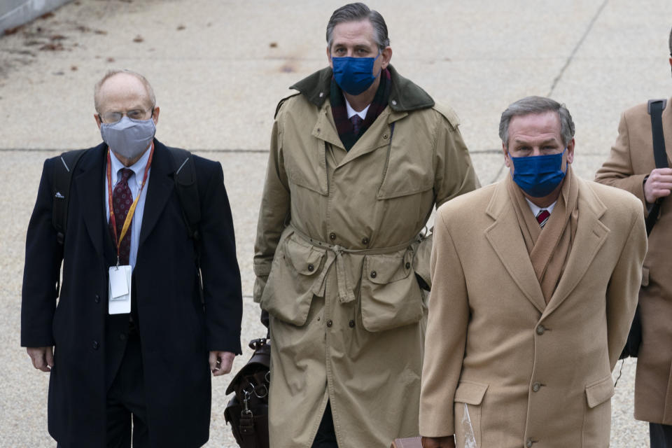 From left, David Schoen, Bruce Castor and Michael van der Veen, lawyers for former President Donald Trump, arrive at the Capitol on the third day of the second impeachment trial of Trump in the Senate, Thursday, Feb. 11, 2021, in Washington. (AP Photo/Jose Luis Magana)