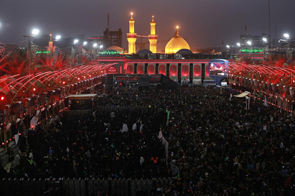 Shiite Muslim worshippers gather in front of the holy shrine of Imam Abbas to mark the Muslim festival of Arbaeen in Karbala, Iraq, Sunday, Oct. 28, 2018. The holiday marks the end of the forty day mourning period after the anniversary of the martyrdom of Imam Hussein, the Prophet Muhammad's grandson in the 7th century. (AP Photo/Hadi Mizban)