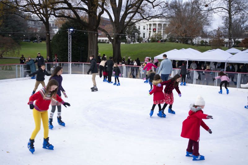Children of local Marine Corps and military-connected families skate on the White House Ice Rink on Wednesday ahead of a Toys for Tots event hosted by first lady Jill Biden at the White House. Photo by Bonnie Cash/UPI