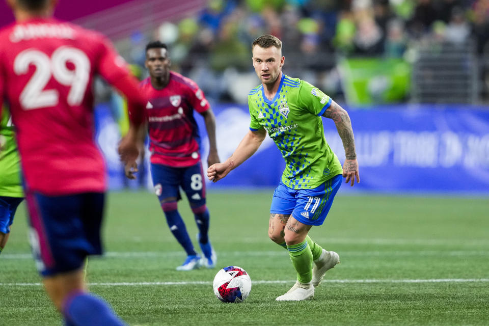 Seattle Sounders midfielder Albert Rusnák (11) moves the ball against FC Dallas defender Sam Junqua (29) during the first half of Game 3 of a first-round playoff MLS soccer match Friday, Nov. 10, 2023, in Seattle. (AP Photo/Lindsey Wasson)