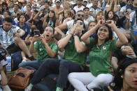 Mexico's soccer fans react as they watch their team's match against Argentina at the World Cup, hosted by Qatar, in Buenos Aires, Argentina, Saturday, Nov. 26, 2022. (AP Photo/Gustavo Garello)