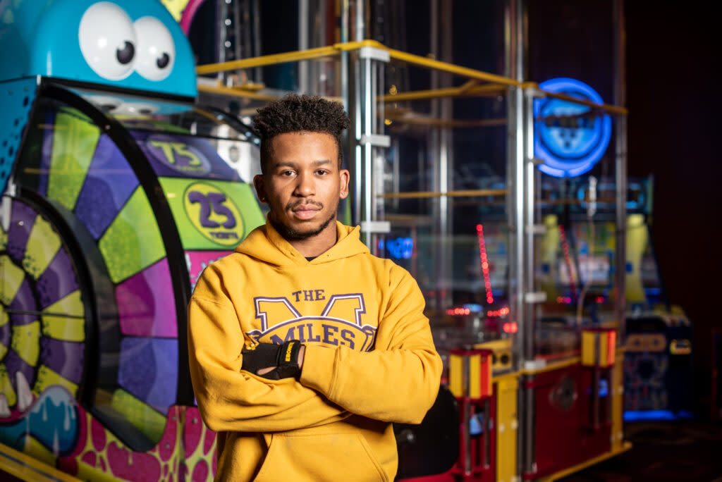 A man standing in front of a stand of games