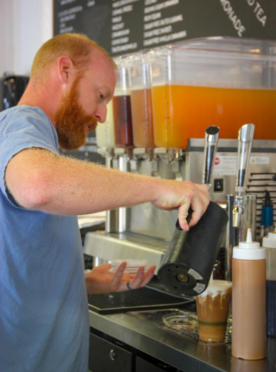 Kyle Finn pours an iced coffee for a customer at Rea's on Wilbur Avenue in Swansea, on Thursday, Aug. 10.