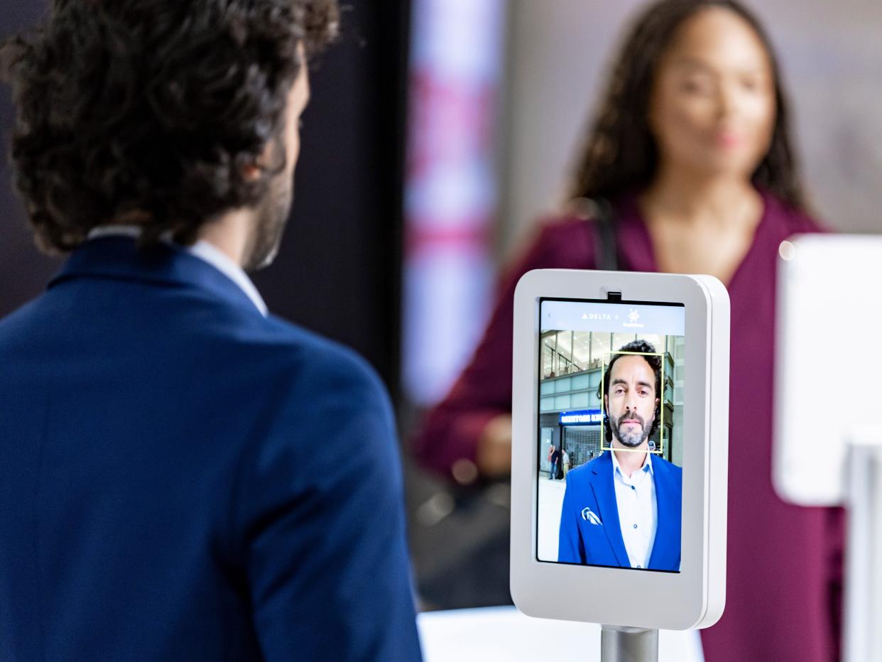 A man uses facial-recognition technology to register to use the Parallel Reality screen.