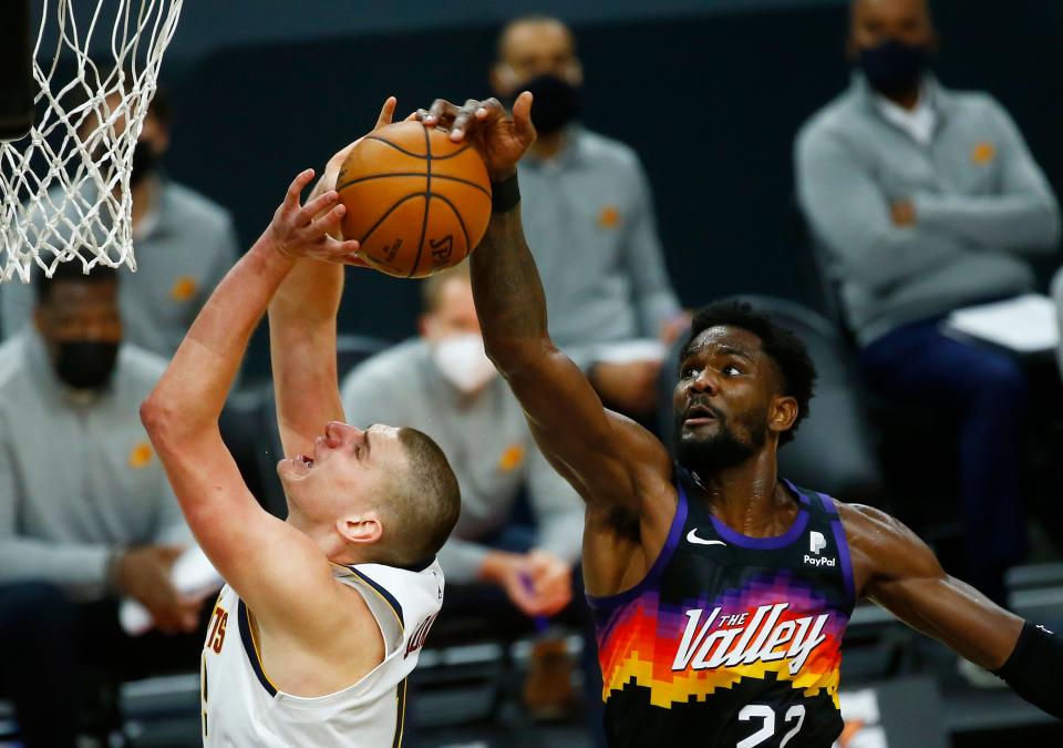 Jan 23, 2021; Phoenix, Arizona, USA; Suns' Deandre Ayton (22) blocks a shot from Nuggets' Nikola Jokic (15) during the second half at the Phoenix Suns Arena. Mandatory Credit: Patrick Breen-Arizona Republic