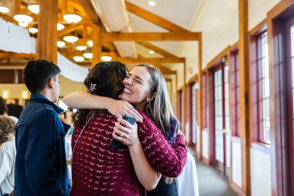 Sarah King, education manager, hugs Ishora Dulal, an alumni of the One Refugee program who’s husband, Biren Dulal, was honored during the One Refugee graduation celebration at the Garden Place at Heritage Park in Salt Lake City on May 8, 2023. | Ryan Sun, Deseret News