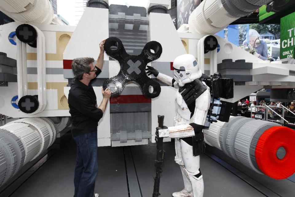 LEGO Master Builder Erik Varszegi and members of the 501st inspect the thrusters of the largest LEGO model ever built, an X-wing Starfighter made from 5.3 million LEGO bricks, upon its reveal in New York City's Times Square, Thursday May 23, 2013. (Amy Sussman/ AP Images for the Lego Group)