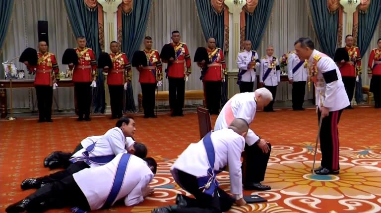 Thai officials present themselves to new Thai King Maha Vajiralongkorn (right) in December