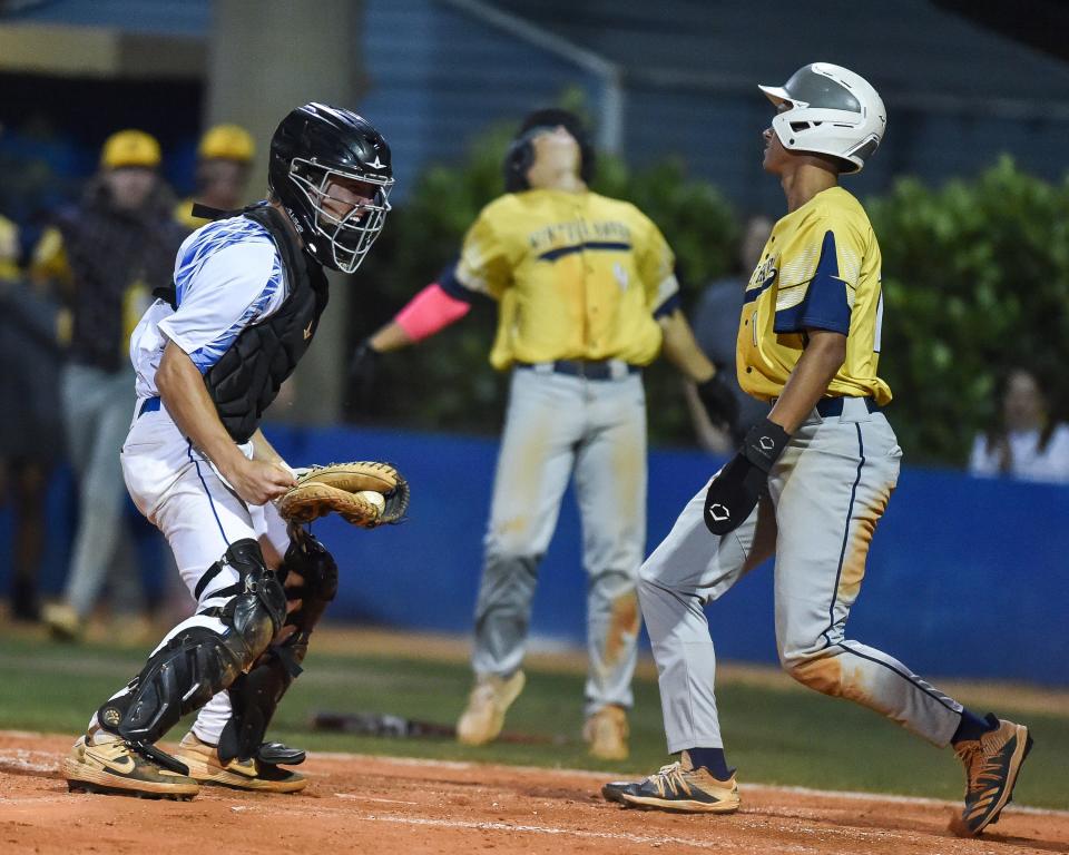 Martin County catcher Dylan Murphy (17) celebrates tagging Winter Haven's Desean Rogers (1) out in the baseball Region 3-6A quarterfinal Tuesday, May 10, 2022, at Martin County High School in Stuart. Martin County lost 4-3.