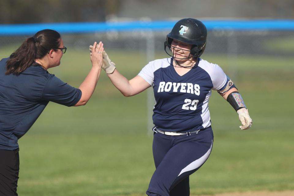 Rootstown catcher Natalie Hammerschmidt gets a high-five from head coach Paige Byers as she rounds third base after her solo home run during Monday’s game against the Mogadore Wildcats.