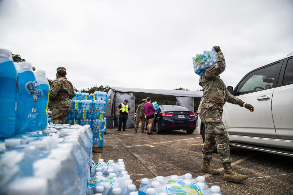 National Guard soldiers and local government employees distribute bottled water to residents in Lake Jackson on Monday. Texas Gov. Greg Abbott issued a disaster declaration on Sunday that extends across Brazoria County, where Lake Jackson is located. (Photo: ASSOCIATED PRESS)