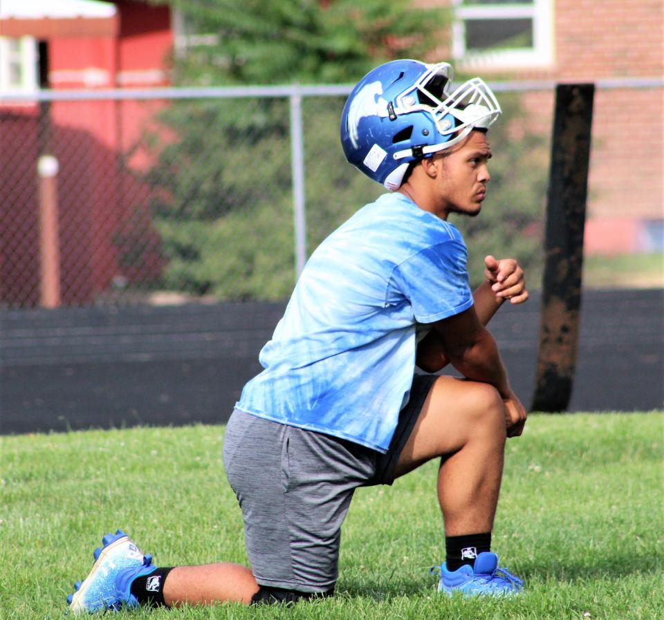 Pueblo Central running back Amari Brown stretches during practice at Pueblo Central High School as the Wildcats prepare for the upcoming season.