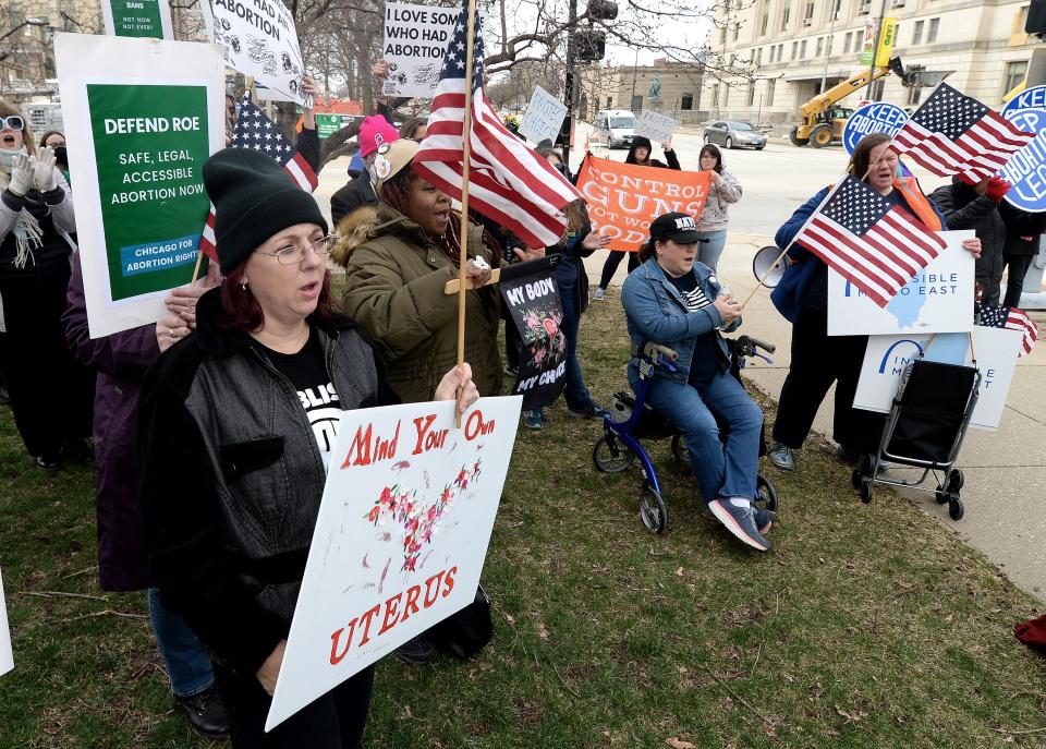 Springfield based activist Heather Dykes, left, attends an abortion rights rally that took place at the corner of Monroe and 2nd Street Tuesday, March 21, 2023.