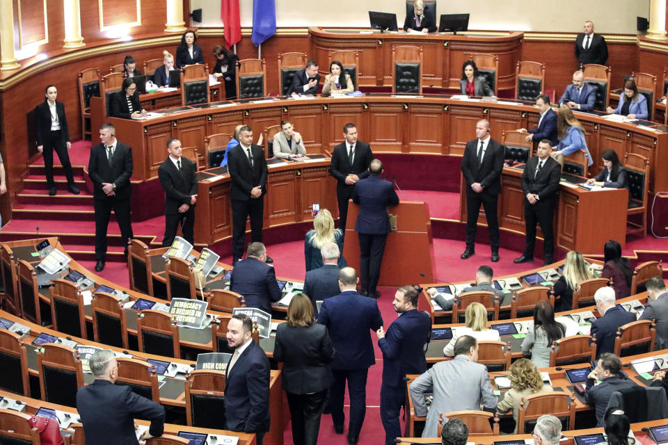 Lawmakers of the Democratic Party, left, look on as their colleagues of the ruling Socialist party vote in Tirana, Albania, Thursday, Feb. 22, 2024. Albania’s Parliament on Thursday approved a deal for the country to hold thousands of migrants rescued in international waters by Italy while their asylum applications are processed, despite protests from opposition lawmakers and human rights groups. (AP Photo/Armando Babani)