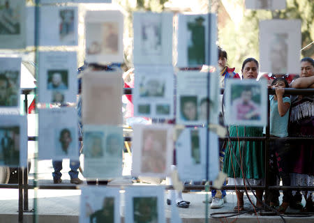 Residents look at pictures of people missing after an explosion of a fuel pipeline ruptured by oil thieves, in the municipality of Tlahuelilpan, state of Hidalgo, Mexico January 21, 2019. REUTERS/Mohammed Salem