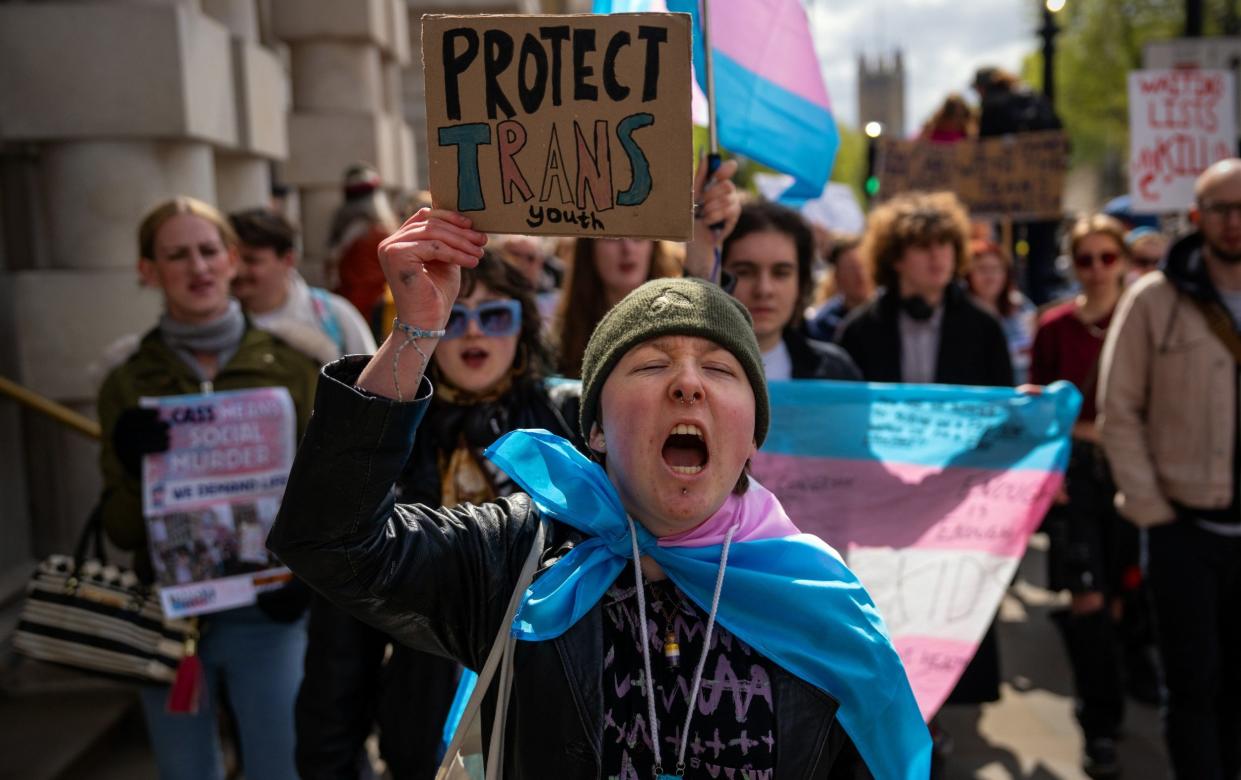 Trans-rights activists protesting against the ban on puberty blockers in London in April