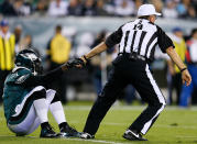 PHILADELPHIA, PA - SEPTEMBER 30: Referee Ron Winter helps quarterback Michael Vick #7 of the Philadelphia Eagles up after being tackled against the New York Giants at Lincoln Financial Field on September 30, 2012 in Philadelphia, Pennsylvania. (Photo by Rob Carr/Getty Images)