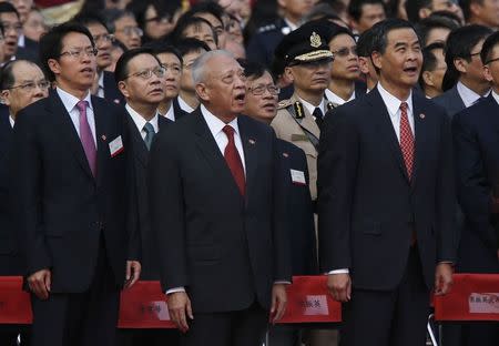 (From L) Zhang Xiaoming, Director of the Liaison Office of the Central People's Government in Hong Kong, former Hong Kong Chief Executive Tung Chee-hwa and Hong Kong Chief Executive Leung Chun-ying sing national anthem during a flag raising ceremony in Hong Kong October 1, 2014, celebrating the 65th anniversary of China National Day. REUTERS/Bobby Yip