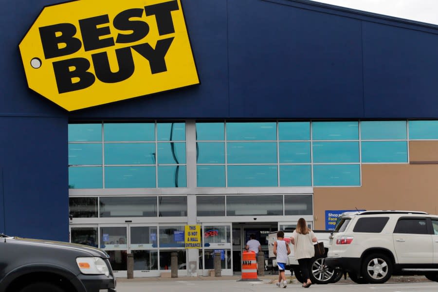 FILE - A woman walks with a boy to the Best Buy store at the Mall of New Hampshire, Tuesday, Aug. 4, 2020, in Manchester, N.H. Best Buy reported declines in fiscal first-quarter sales and profits, Friday, May 25, 2023 as the nation’s largest consumer electronics chain continues to wrestle with a consumer spending slowdown in gadgets. However, the company’s profit beat Wall Street expectations even as sales were below expectations. (AP Photo/Charles Krupa, File)