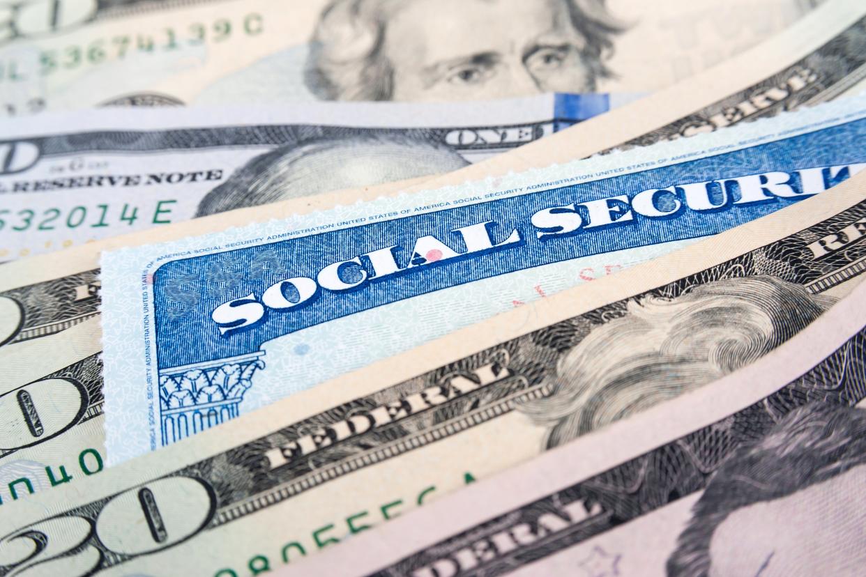 Social security card and U.S. dollar bills