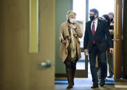 FILE - In this Oct. 26, 2020, file photo, Dr. Deborah Birx, White House Coronavirus Response Coordinator, left, walks with North Dakota Gov. Doug Burgum after holding a roundtable discussion with state and local government and medical leaders on the campus of Bismarck State College, in Bismarck, N.D. With coronavirus cases soaring in North Dakota, Burgum has allowed the state's beleaguered hospitals to use infected but asymptomatic doctors and nurse to treat COVID-19 patients. (Mike McCleary/The Bismarck Tribune via AP, File)