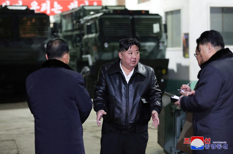 North Korean leader Kim Jong Un speaks to officials at a munitions factory (via REUTERS)