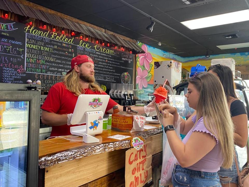 Tyler Peak hands a sweet treat to a customer at Tropical Vibes in Key West.