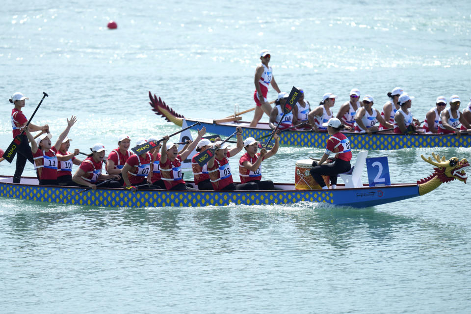 China's dragon boat team celebrates after finishing first in the Women's Dragon Boat 200m Grand Final during the 19th Asian Games at the Wenzhou Dragon Boat Center in Wenzhou, China, Wednesday, Oct. 4, 2023. (AP Photo/Eugene Hoshiko)