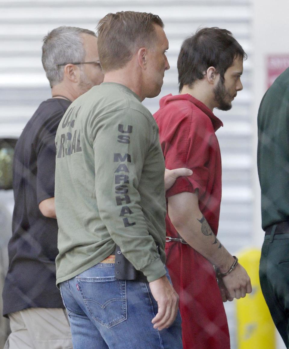 FILE- In this Jan. 9, 2017 file photo, Esteban Santiago, right, accused of fatally shooting several people and wounding multiple others at a crowded Florida airport baggage claim, is returned to Broward County's main jail after his first court appearance in Fort Lauderdale, Fla. Authorities say such walk-ins are a daily occurrence around the country. Assessing whether the people are reporting a credible threat or whether they need medical help is extremely difficult and drains already-stretched law enforcement resources. (AP Photo/Alan Diaz, File)