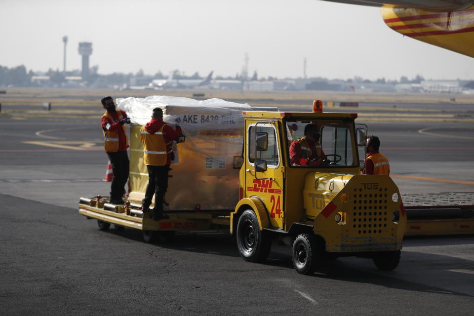 The first shipment of the Pfizer COVID-19 vaccine to Mexico is transported on the tarmac after being unloaded from a DHL cargo plane at the Benito Juarez International Airport in Mexico City, Wednesday, Dec. 23, 2020. (AP Photo/Eduardo Verdugo)