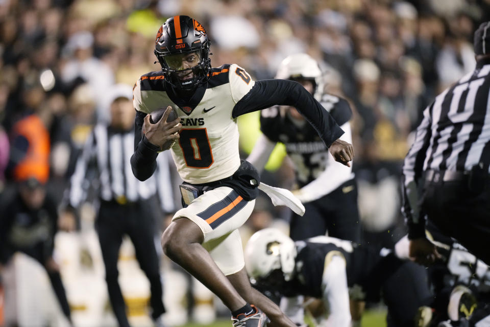 Oregon State quarterback Aidan Chiles runs for a touchdown against Colorado in the first half of an NCAA college football game Saturday, Nov. 4, 2023, in Boulder, Colo. (AP Photo/David Zalubowski)