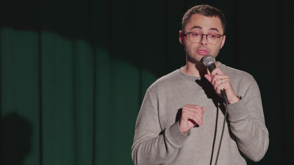 Joe Mande talking during a comedy show