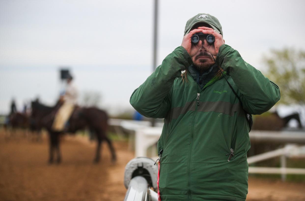 Veterinarian Nick Smith keeps on eye on horses during a warm-up on the opening of the Spring Meet at Keeneland in Lexington Friday. April 7, 2023