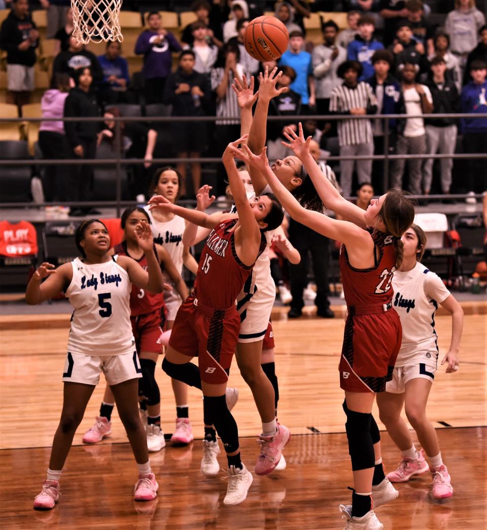 Ballinger's Emma Perkins (15) and Ashtyn Wilson (22) battle a Wichita Falls City View player for a rebound in the second half.