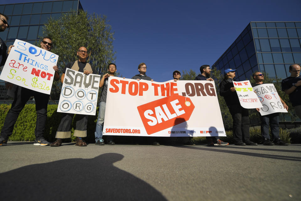 About 15 people protest Friday, Jan. 24, 2020, in Los Angeles outside the headquarters of the regulatory body for domain names, the Internet Corporation for Assigned Names and Numbers. The company that controls the dot-org online universe is putting the registry of domain names up for sale, and the nonprofits that often use the suffix in their websites are raising concerns about the move. ICANN is meeting this weekend and is expected to rule by mid-February on plans by private-equity firm Ethos Capital to buy the Public Interest Registry for $1.1 billion. (AP Photo/Mark J. Terrill)