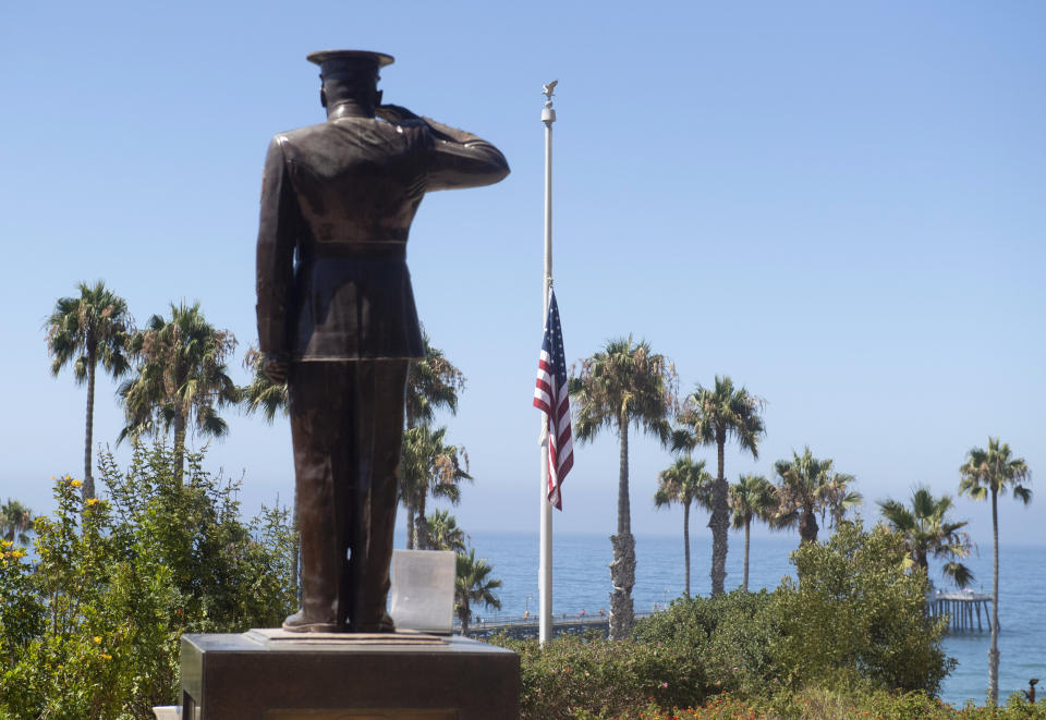 The U.S. flag was lowered to half-staff at Park Semper Fi in San Clemente, Calif., on Friday, July 31, 2020. Officials say a military seafaring assault vehicle with 15 Marines and a Navy sailor aboard sank off the coast of Southern California, leaving one of the Marines dead and eight missing. A Marine Corps spokesman says they were traveling in the amphibious assault vehicle from the shores of San Clemente Island to a Navy ship Thursday evening when they reported that the vehicle was taking on water. (Paul Bersebach/The Orange County Register via AP)