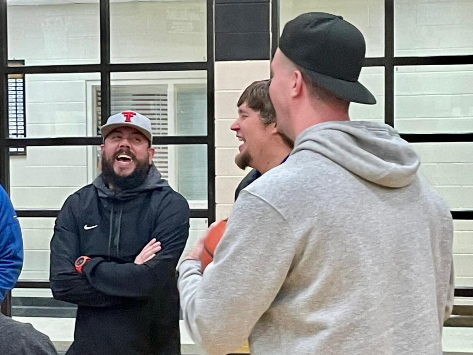 Josh Benningfield (left), B.C. Lee (middle) and Zach Jones laugh while talking after the Merkel-Clyde game. All three were players on the 2002-03 Cooper boys' basketball team.