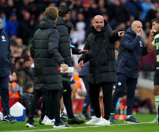 Manchester City boss Pep Guardiola and Liverpool manager Jurgen Klopp discuss touchline