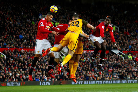 Soccer Football - Premier League - Manchester United vs Brighton & Hove Albion - Old Trafford, Manchester, Britain - November 25, 2017 Manchester United's Chris Smalling and Paul Pogba in action with Brighton’s Shane Duffy Action Images via Reuters/Jason Cairnduff